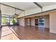 Open and airy screened-in lanai with wood-look tile flooring, featuring a built-in outdoor kitchen at 1201 Creekview Ct, St Cloud, FL 34772