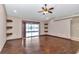 Living room with hardwood floors, sliding door, and modern ceiling fan at 1201 Creekview Ct, St Cloud, FL 34772