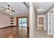 Spacious living room with hardwood floors, ceiling fan and sliding glass doors to the screened in patio at 1201 Creekview Ct, St Cloud, FL 34772