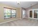 Neutral-toned living room with large window and a decorative lighting fixture at 1201 Creekview Ct, St Cloud, FL 34772