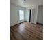 Bright bedroom features wood-look flooring, a window, and a double-door closet at 2147 Sw 3Rd St, Ocala, FL 34471