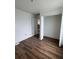 Bright bedroom featuring wood-look floors, fresh paint, and a closet at 2147 Sw 3Rd St, Ocala, FL 34471