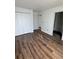 Bedroom with wood-look floors features a double-door closet and white trim at 2147 Sw 3Rd St, Ocala, FL 34471