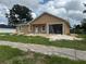 New construction home with light tan exterior, white trim, attached garage, and landscaping in progress at 2147 Sw 3Rd St, Ocala, FL 34471
