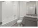 Clean bathroom featuring tile flooring, granite countertop, and tub with white tile surround at 5530 Nw 40Th Loop, Ocala, FL 34482
