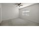 Carpeted bedroom with ceiling fan and natural light from a window at 5530 Nw 40Th Loop, Ocala, FL 34482