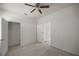 Bedroom with neutral carpeting, ceiling fan, closet, and lots of natural light at 5530 Nw 40Th Loop, Ocala, FL 34482