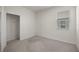 Bedroom showcasing neutral carpeting, closet with white shelving, and natural light at 5530 Nw 40Th Loop, Ocala, FL 34482