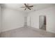 Bedroom featuring neutral carpet, ceiling fan, and access to attached bathroom with glass enclosed shower at 5530 Nw 40Th Loop, Ocala, FL 34482