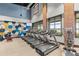 Bright fitness center featuring modern treadmills, weights, and a geometric accent wall at 5530 Nw 40Th Loop, Ocala, FL 34482