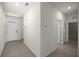 Hallway view featuring tile flooring and access to the front door at 5530 Nw 40Th Loop, Ocala, FL 34482