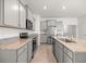 Bright kitchen boasting granite counters, stainless appliances, grey cabinetry and center island with sink at 5530 Nw 40Th Loop, Ocala, FL 34482