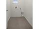 Practical laundry room features tile flooring and utility connections at 5530 Nw 40Th Loop, Ocala, FL 34482
