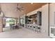 Outdoor bar with seating, overhead fan, and views of the golf course at 5530 Nw 40Th Loop, Ocala, FL 34482