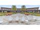 Beautiful outdoor patio with white Adirondack chairs, lush landscaping, and lounge furniture at 5530 Nw 40Th Loop, Ocala, FL 34482