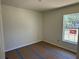 Neutral bedroom with large window and flooring prepped for renovation at 714 Nw 2Nd St, Ocala, FL 34475