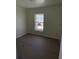 An unfinished bedroom features a window allowing natural light in the new construction home at 714 Nw 2Nd St, Ocala, FL 34475