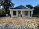 New home with white siding and covered front porch, ready for landscaping at 714 Nw 2Nd St, Ocala, FL 34475