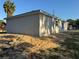 Back exterior of a single-story house featuring stucco and a newly graded yard at 714 Nw 2Nd St, Ocala, FL 34475