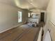 Open-concept living room and kitchen with vaulted ceiling and unfinished flooring at 714 Nw 2Nd St, Ocala, FL 34475