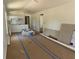 Bright, open-concept living room with kitchen and unfinished flooring at 714 Nw 2Nd St, Ocala, FL 34475