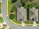 A top-down aerial captures a well-kept residence on a manicured lot with blooming foliage at 9230 Sw 66Th Loop, Ocala, FL 34481