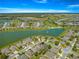 This aerial view shows a home in a community next to a scenic lake at 9230 Sw 66Th Loop, Ocala, FL 34481