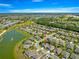 This aerial view showcases a home in a neighborhood near a golf course and lake at 9230 Sw 66Th Loop, Ocala, FL 34481