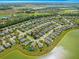 This aerial view shows the home's position in a community by a lake at 9230 Sw 66Th Loop, Ocala, FL 34481