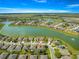 This aerial view shows a home in a community with lake and fountain views at 9230 Sw 66Th Loop, Ocala, FL 34481