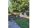 Relaxing backyard setup with lawn chairs beneath a large tree, complemented by vibrant flower arrangements at 9230 Sw 66Th Loop, Ocala, FL 34481