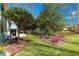 Green backyard with manicured garden beds and patio at 9230 Sw 66Th Loop, Ocala, FL 34481