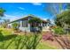 Well-manicured backyard with lush landscaping, a patio, and a serene atmosphere at 9230 Sw 66Th Loop, Ocala, FL 34481