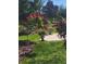 Lush backyard featuring colorful flower arrangements, potted plants, and a serene garden path at 9230 Sw 66Th Loop, Ocala, FL 34481