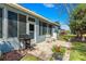 Backyard patio with a grill and outdoor seating surrounded by beautiful flowers and landscaping at 9230 Sw 66Th Loop, Ocala, FL 34481