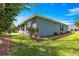 The backyard features a well-maintained lawn, mature trees, and a screened lanai for outdoor relaxation at 9230 Sw 66Th Loop, Ocala, FL 34481