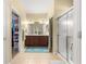 Bright bathroom featuring a double vanity, walk-in shower and walk-in closet at 9230 Sw 66Th Loop, Ocala, FL 34481