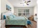 Bright bedroom with a king bed, ceiling fan, and a large window at 9230 Sw 66Th Loop, Ocala, FL 34481