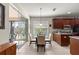 Bright breakfast nook with glass table and chairs, adjacent to the kitchen and screened lanai at 9230 Sw 66Th Loop, Ocala, FL 34481