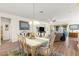 Well-lit dining area adjacent to the living room, featuring wood floors and comfortable seating at 9230 Sw 66Th Loop, Ocala, FL 34481