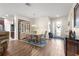 Open-concept dining room with hardwood floors, stylish furniture, and bright natural light at 9230 Sw 66Th Loop, Ocala, FL 34481