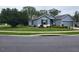 Charming single-story home featuring a well-manicured lawn, mature trees, and a two-car garage at 9230 Sw 66Th Loop, Ocala, FL 34481