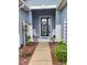 Inviting front porch with potted plants, chairs, and a decorated glass door at 9230 Sw 66Th Loop, Ocala, FL 34481