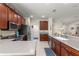 Open kitchen with stainless steel appliances, wood cabinets, and view of the dining area at 9230 Sw 66Th Loop, Ocala, FL 34481