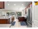 Open concept kitchen featuring stainless appliances and dark cabinets with seating at 9230 Sw 66Th Loop, Ocala, FL 34481