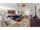 Open-concept living room with stylish furniture, connecting to a dining area and modern kitchen at 9230 Sw 66Th Loop, Ocala, FL 34481