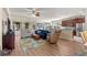 Bright and airy living room featuring hardwood floors, comfortable seating, and an adjacent kitchen area at 9230 Sw 66Th Loop, Ocala, FL 34481
