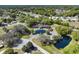 Gorgeous aerial view of a lush community, showcasing a beautiful clubhouse, serene ponds, and meticulously maintained landscaping at 10740 Sw 62Nd Avenue Rd, Ocala, FL 34476