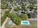 Stunning aerial view showcasing a sparkling community pool, shuffleboard courts, and lush greenery enhancing outdoor enjoyment at 10740 Sw 62Nd Avenue Rd, Ocala, FL 34476