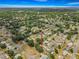 An aerial view of a home situated in a neighborhood of tree-lined streets and well-maintained residences at 10954 Sw 83Rd Ct, Ocala, FL 34481